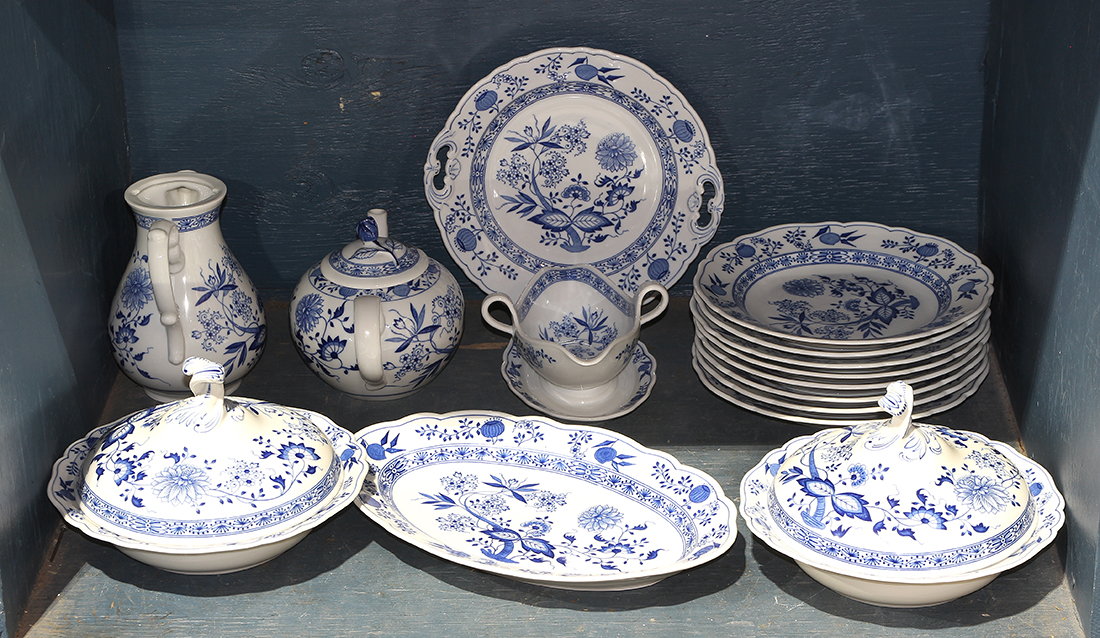 One shelf of a partial Bavarian porcelain table service, in the style of Meissen's "Blue Onion"