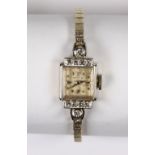 Lady's diamond and 14k white gold wristwatch Dial: square, white, applied dot and point hour