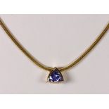 Tanzanite and 14k yellow gold pendant-necklace Featuring (1) triangular-cut tanzanite, weighing