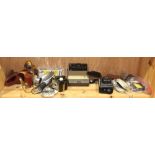 One shelf of vintage photography items, including an Adams 35 mm black and chrome camera body, a