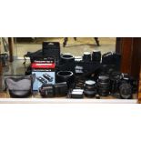 One shelf of vintage camera and lens group, consisting of a Canon EOS film camera, (2) Canon lenses,