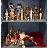 Two shelves of Christmas decorations, primarily consisting of assorted German nutcrackers,