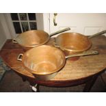 A set of 3 graduated antique copper saucepans