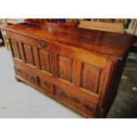 An 18th century oak mule chest of panel construction with 3 plank top