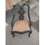 A 19th century papier mache chair with mother of pearl inlay and cane seat