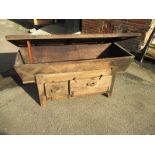 An 18th century provincial baker’s dough box, with drawer and cupboard base and chip carved