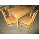 A waxed pine kitchen table and 2 chairs