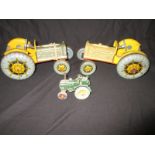 Two 1950's tin plate and plastic toy tractors and a die-cast example