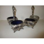 A pair of silver double salt dishes with blue glass liners