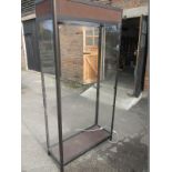 A large glazed shop display cabinet with 3 shelves