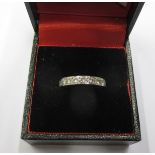 An unmarked gold ring set with 9 diamonds