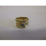 An 18ct yellow gold ring set with a sapphire and 2 diamonds, approx weight 13g