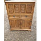 A vintage oak cocktail cabinet with 2 central drawers and cupboard base