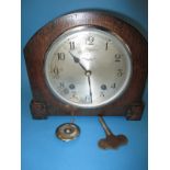 An oak cased mantle clock by Garrard, retailed by Munsey & Co Ltd Cambridge
