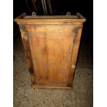 An antique pine wall hanging cupboard