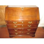 A Georgian oak bureau with manual loapers and secret compartments