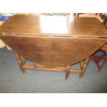 An antique oak gate leg table