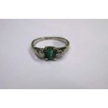 An Art Deco platinum, Diamond and Emerald ring