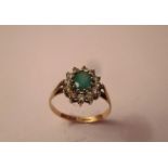 A 9ct gold, CZ and emerald ring