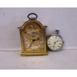 A vintage travel clock and a pocket watch