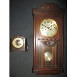An oak cased wall clock and a mantle clock