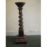 A mahogany torchiere with barley twist column