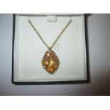 A 9ct gold necklace with a large citrene pendant