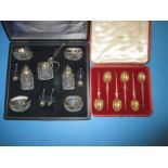 A boxed silver mounted cruet set and a boxed set of gilt silver spoons in Goldsmiths box