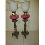 Two vintage oil lamps with glass reservoirs