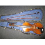 A vintage violin in hard case with 2 bows