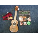 A soprano ukulele and a miniature violin in case