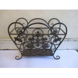 A wrought iron magazine rack