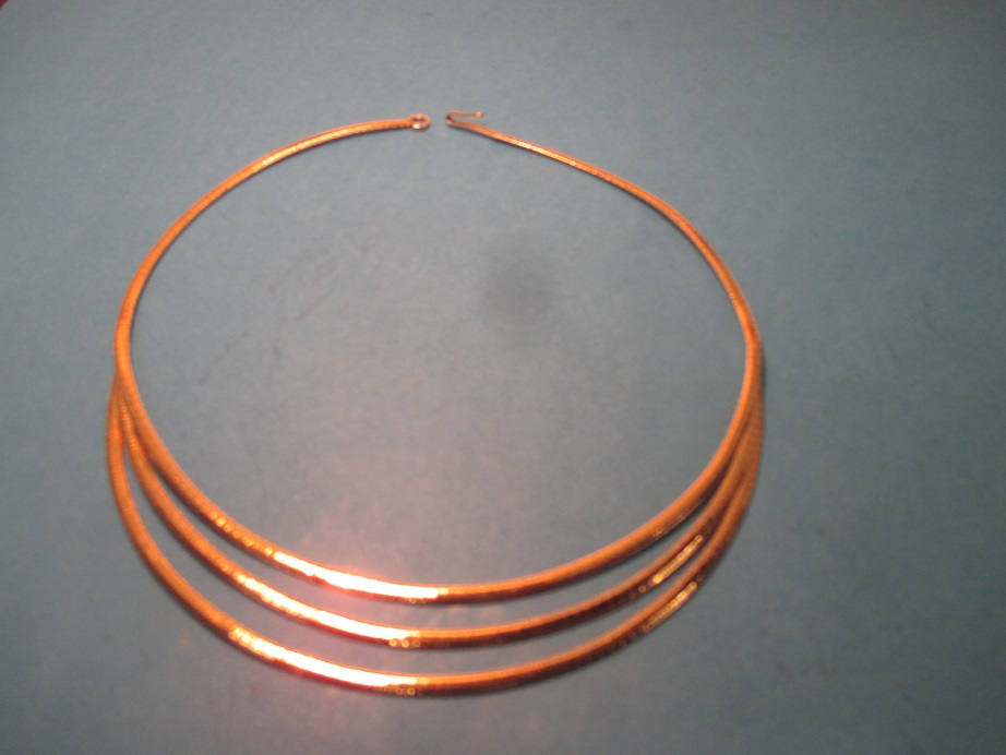 An um-marked but tested gold triple front section neck collar, approx. weight 33g