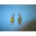 A pair of 9ct yellow gold peridot drop earrings