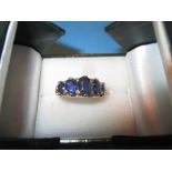 An unmarked gold 5 stone sapphire half hoop ring, approx. size M