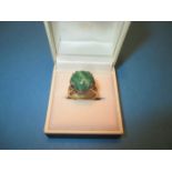 An 18ct yellow gold and jade ring, approx. size M