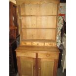 A small vintage stripped pine kitchen dresser