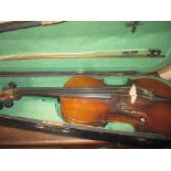 A vintage violin in hard case with bow
