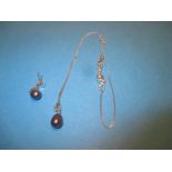 A 9ct white gold diamond a grey freshwater pearl necklace pendant and chain with similar earring