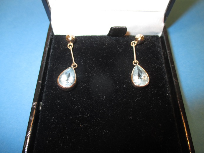 A pair of 9ct yellow gold teardrop shaped aquamarine drop earrings