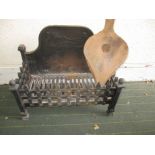 A wrought iron fire basket with vintage bellows