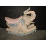 A solid carved wood rocking elephant