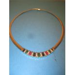 A 14ct yellow gold diamond ruby sapphire and emerald neck collar