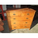A late 19th early 20th century walnut chest of 2 short over 3 long graduated drawers