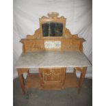 A 19th century Irish stripped pine wash stand with marble top