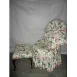 An upholstered chair and foot stool