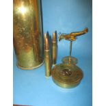 WWII shell cases and a brass aeroplane