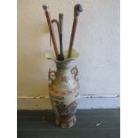 3 walking sticks and a silver mounted parasol in ceramic stand