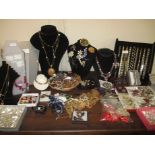 A large quantity of costume jewellery and jewellery display stands