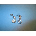 A pair of 18ct white gold earrings, each drop set with a single diamond and pearl